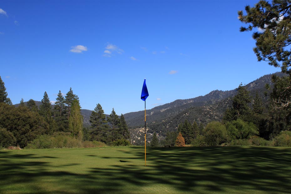 Blue flag on green at Pine Mountain Club golf course