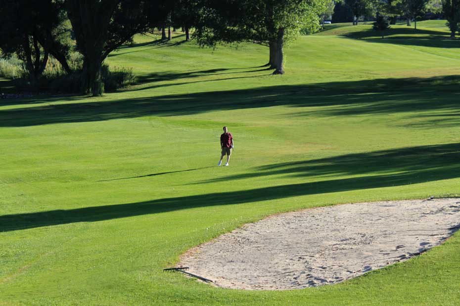 Golfer near bunker edge at Pine Mountain Club golf course