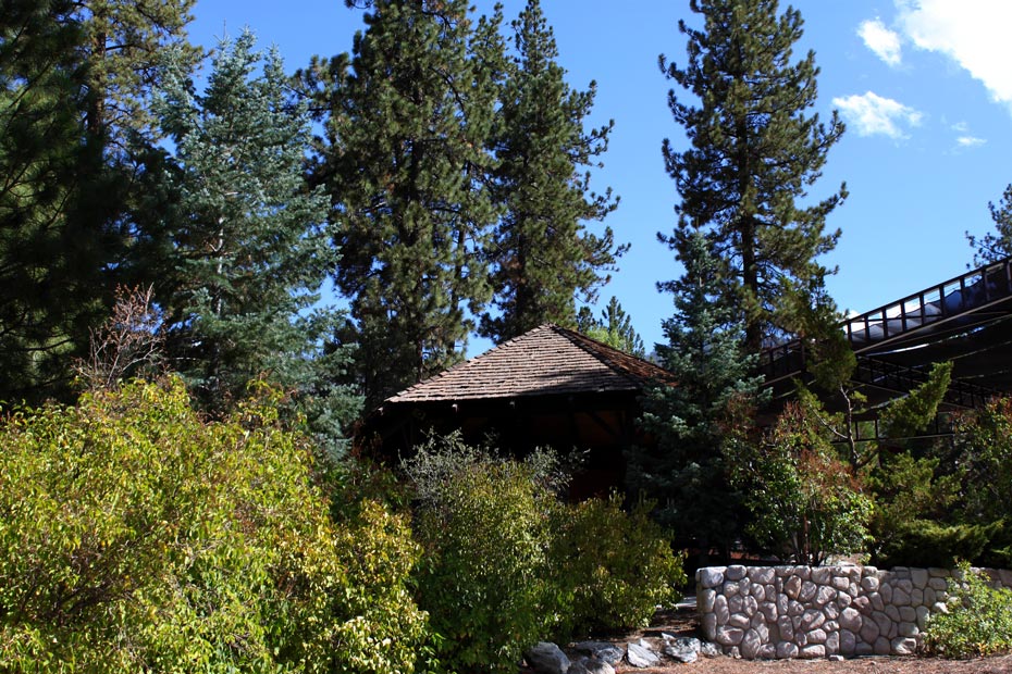 Village gazebo and stone wall in Pine Mountain Club surrounded by greenery