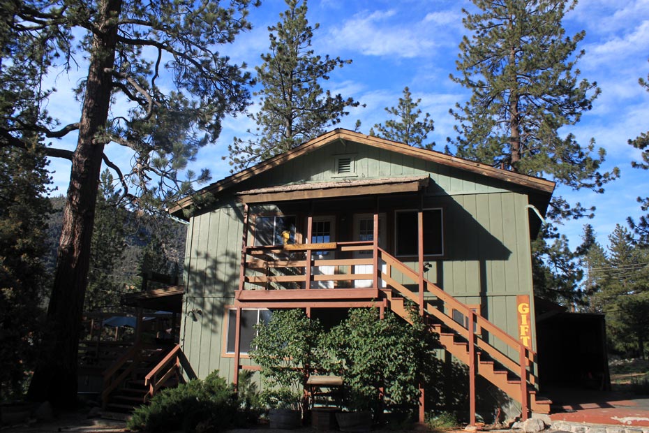 Green village building with outdoor deck in Pine Mountain Club