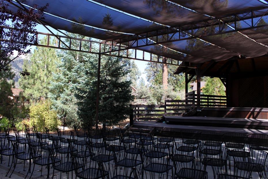 Outdoor stage seating area in Pine Mountain Club village beneath a covered roof