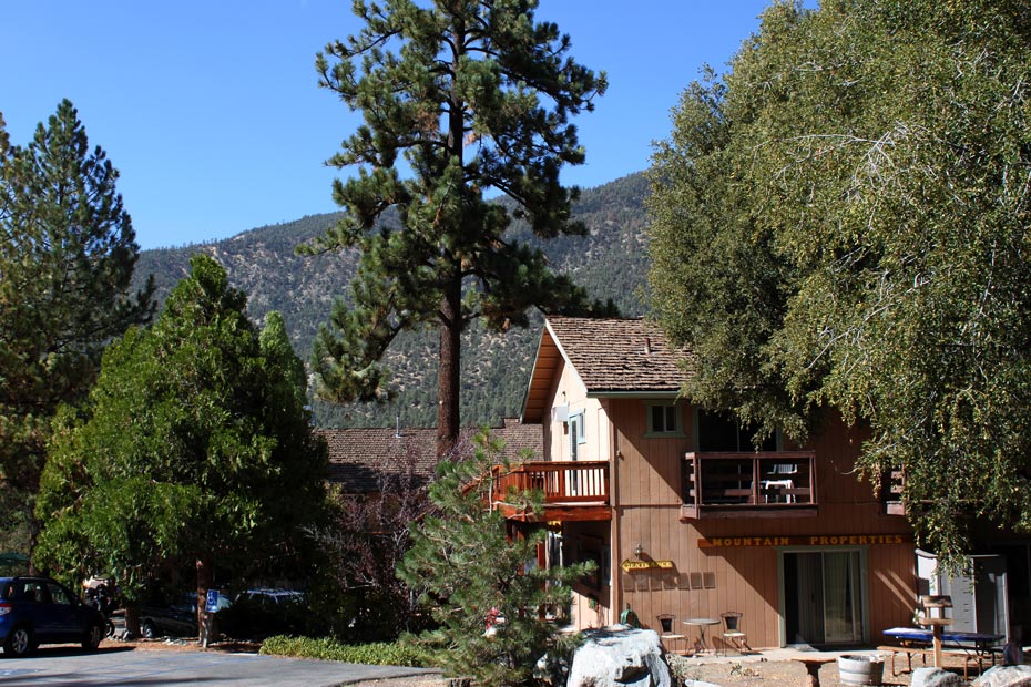 Rustic village building in Pine Mountain Club with mountain trees in the background
