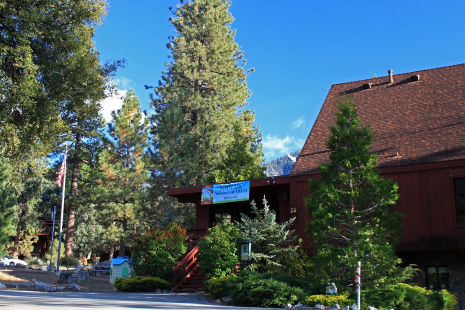 Blue village sign and red building in Pine Mountain Club