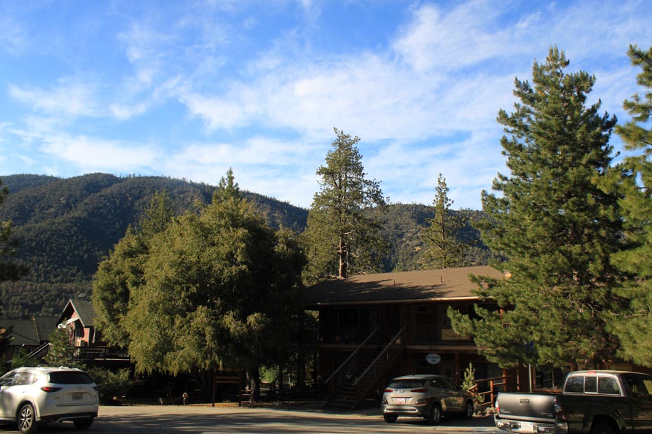 Pine Mountain Club village road with hillside shops and mountain views