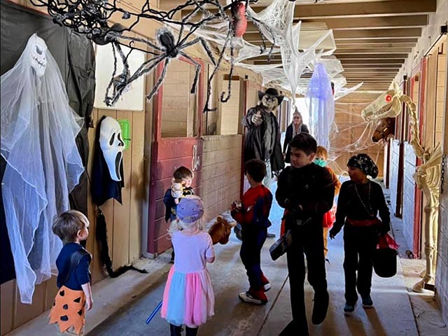 Kids inside haunted barn at Halloween Spooktacular Barn Bash Pine Mountain Club