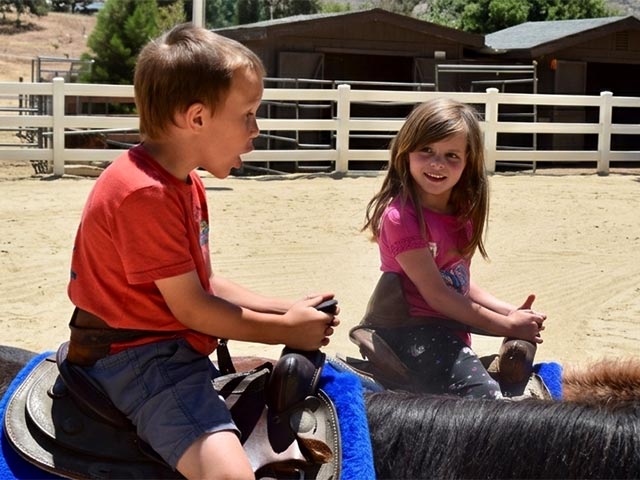 Kids riding horses at Saddle Up Saturday event Pine Mountain Club Equestrian Center